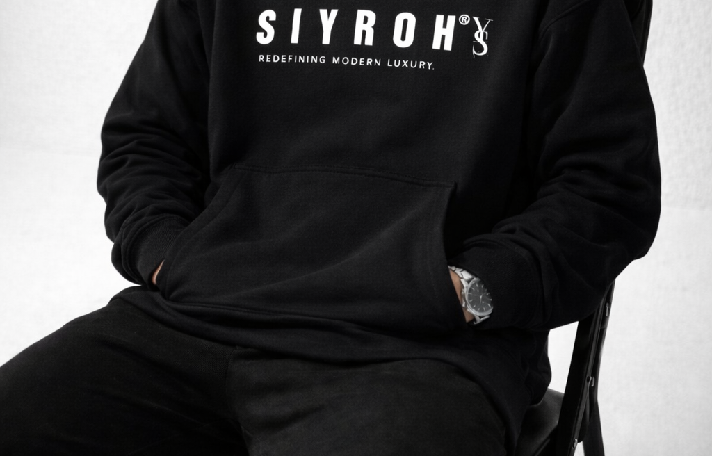 Man wearing a black hoodie with 'SIYROH' branding on a light gray background